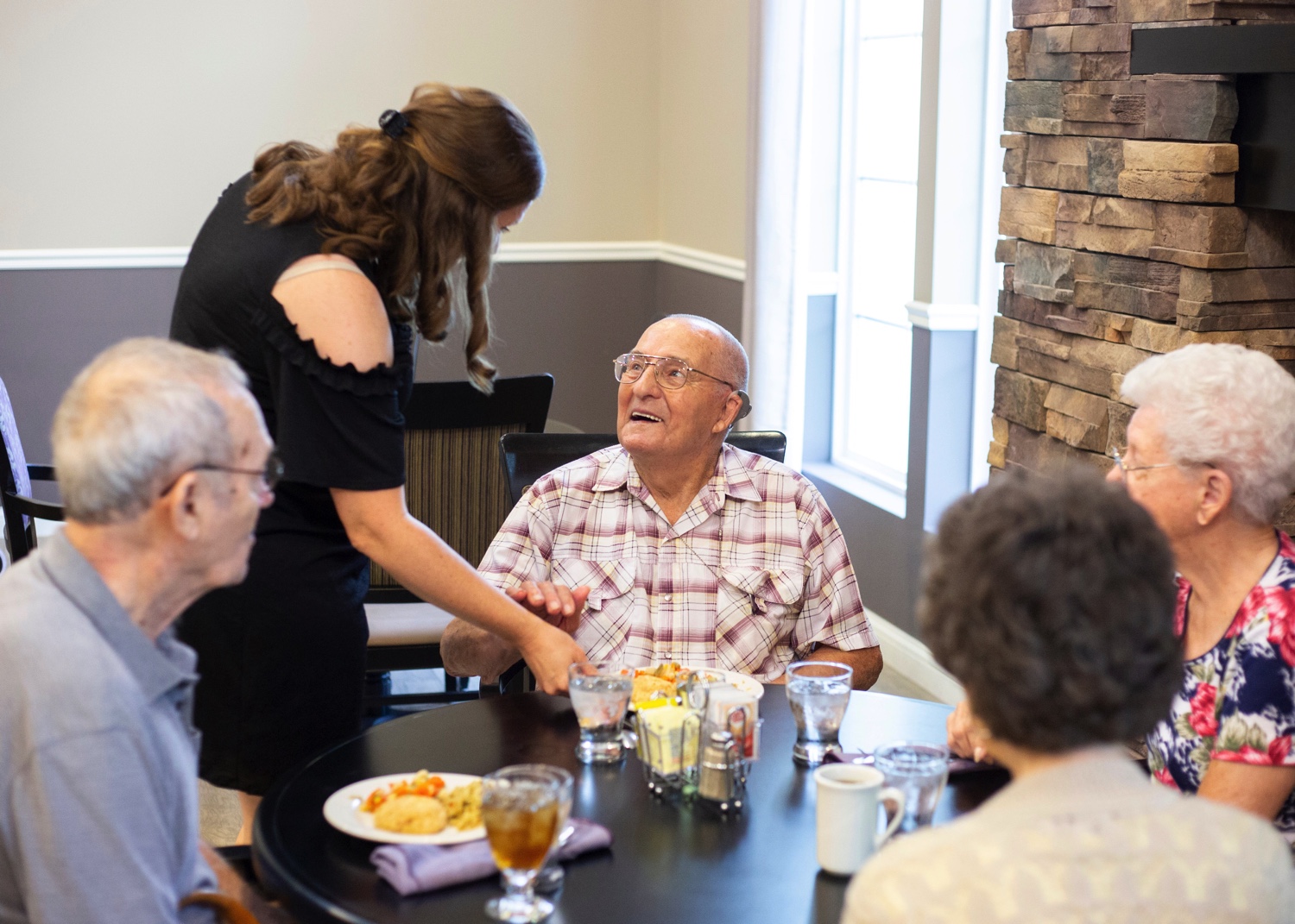 Staff Cargiver Serving Resident Meal