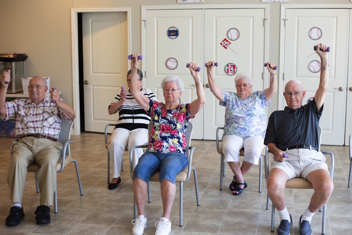 Residents participating in a seated exercise class