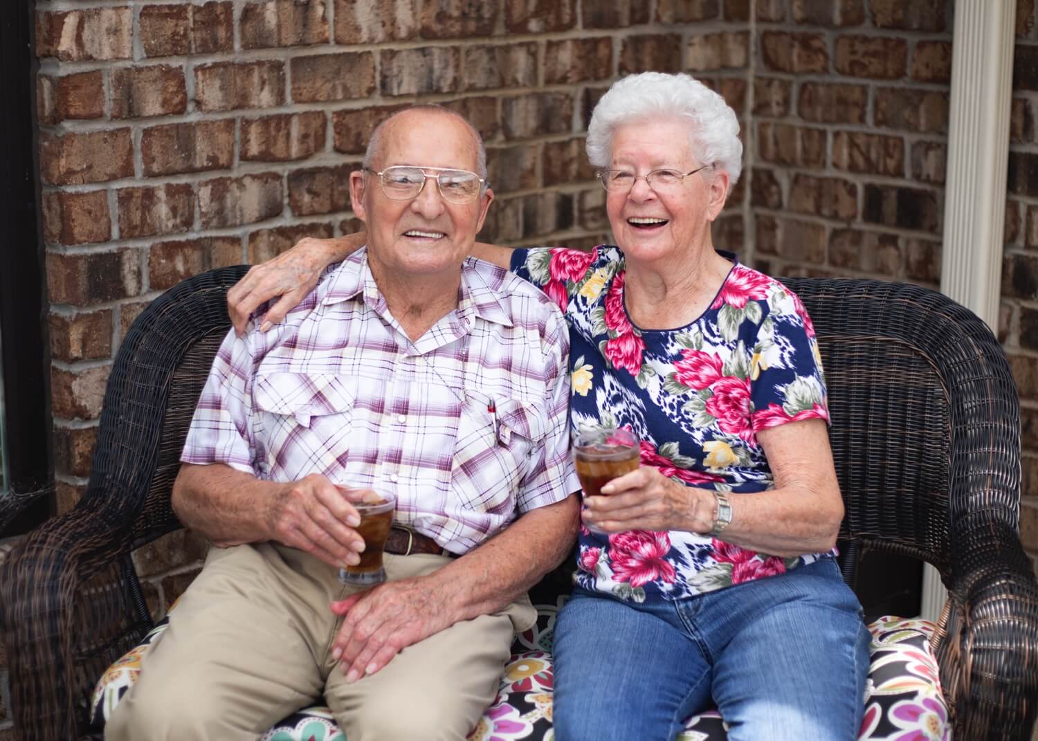 Two Residents Holding Drinks Smiling