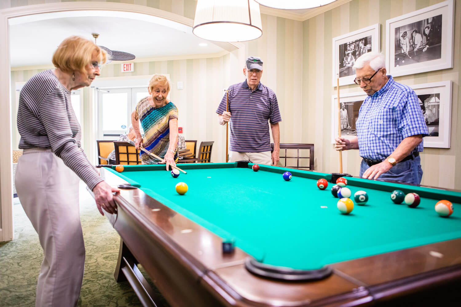 Four residents playing pool