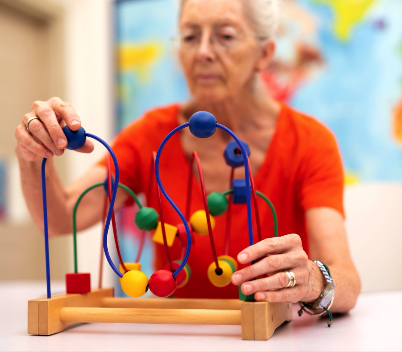 A senior resident playing with a sensory-stimulating toy