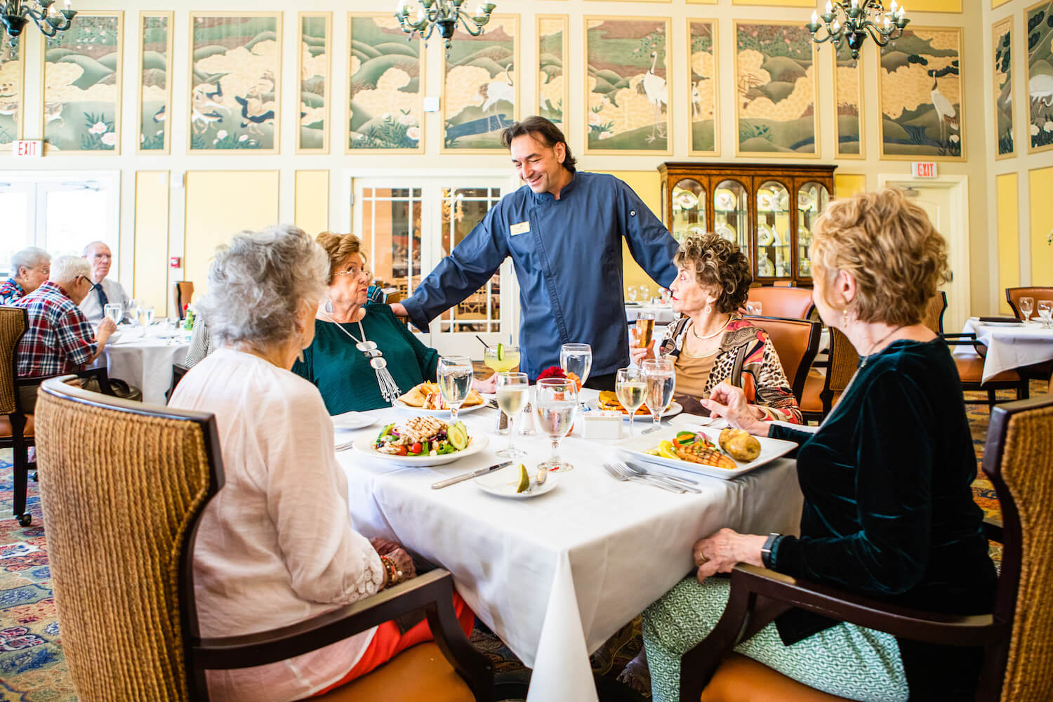 Chef talking with seniors at the restaurant