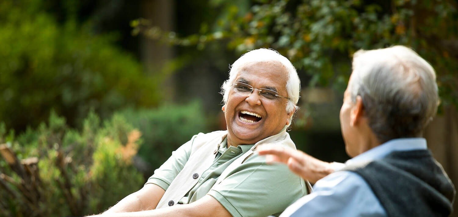 senior friends laughing together outside