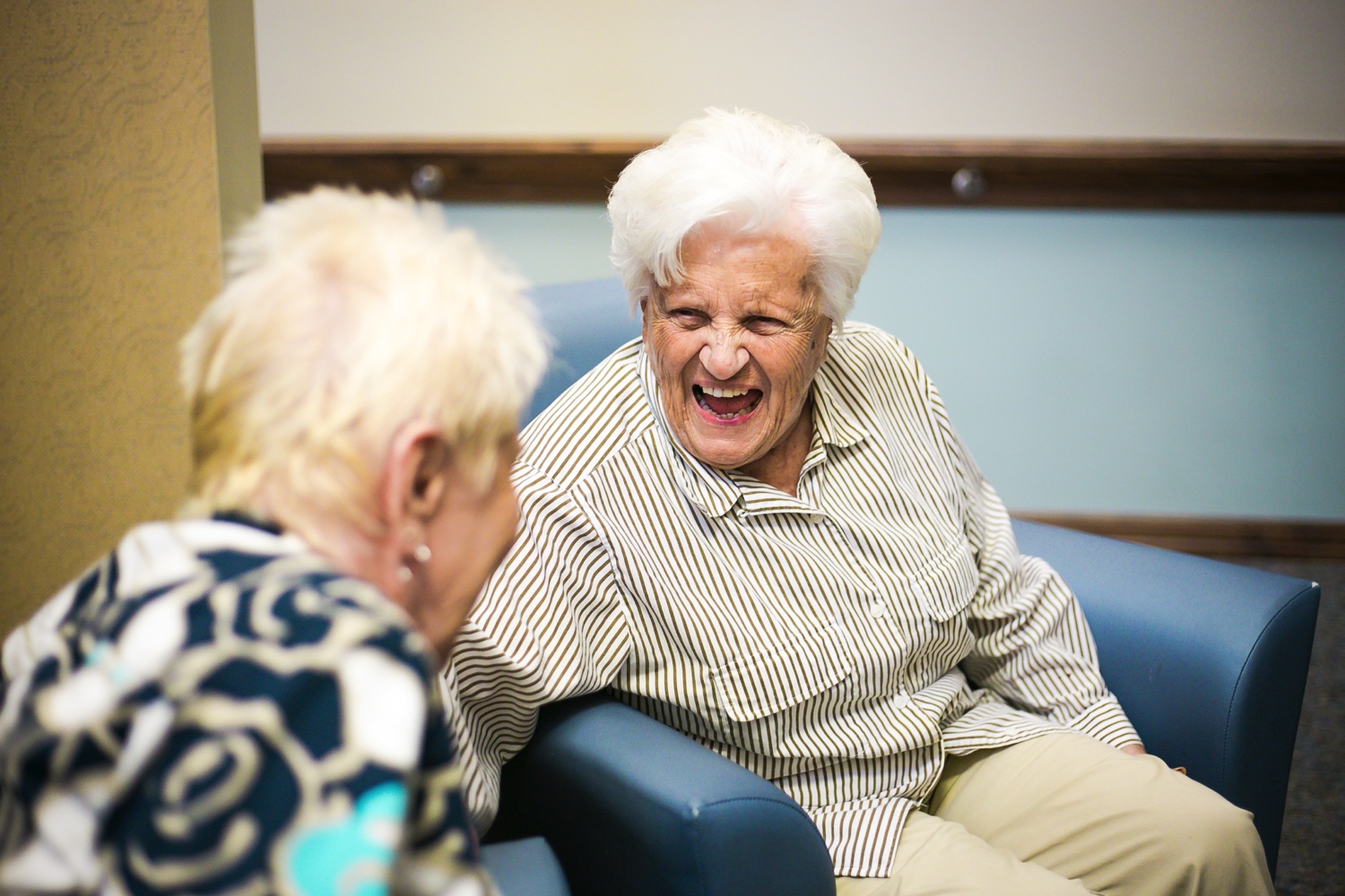 Two senior friends laughing