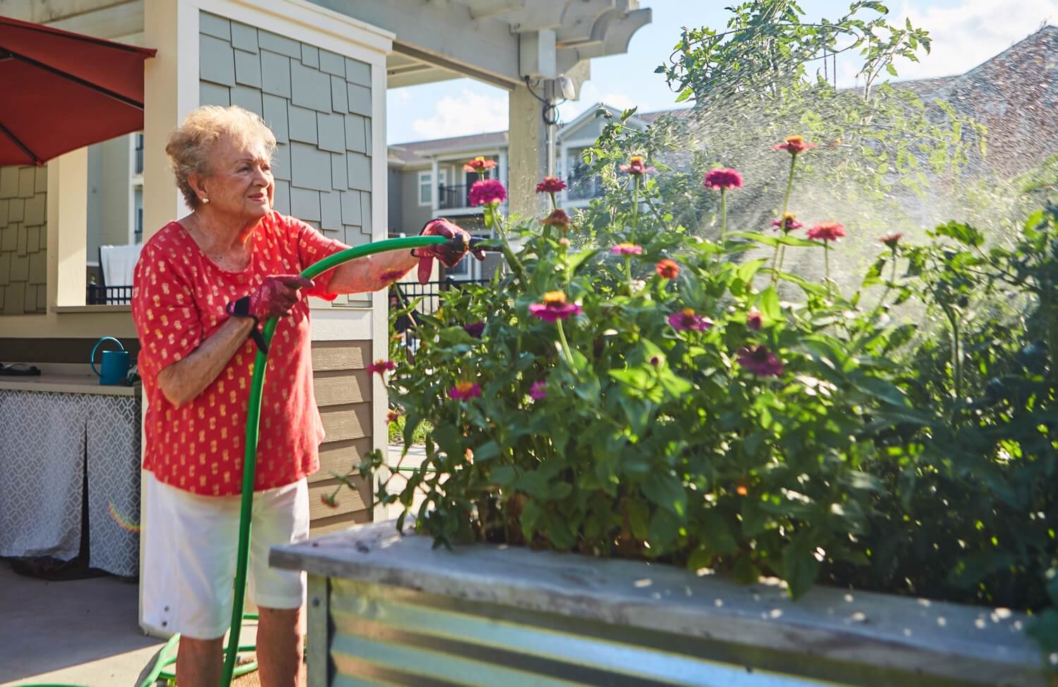 Senior woman watering plants