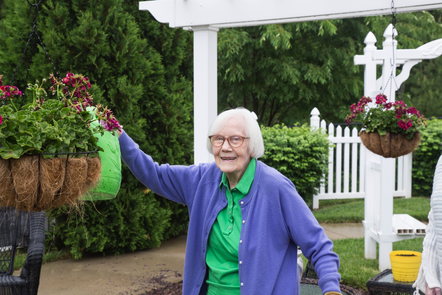 senior Resident watering plants in a Gardening