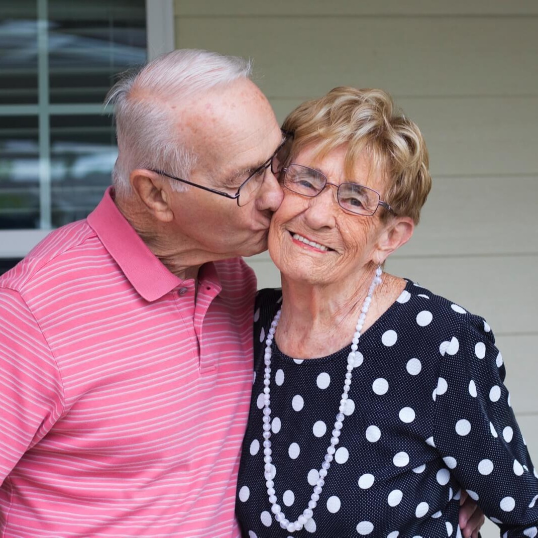 Senior couple kissing and smiling