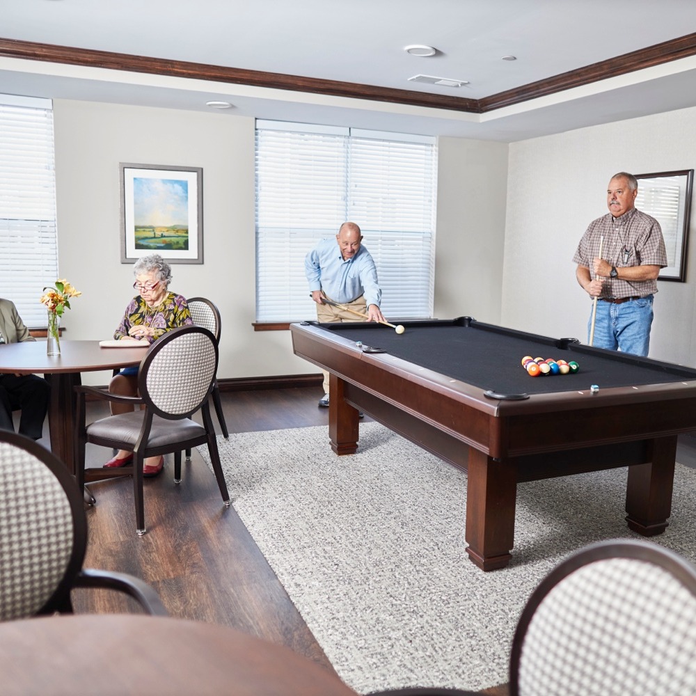 Residents reading and playing pool
