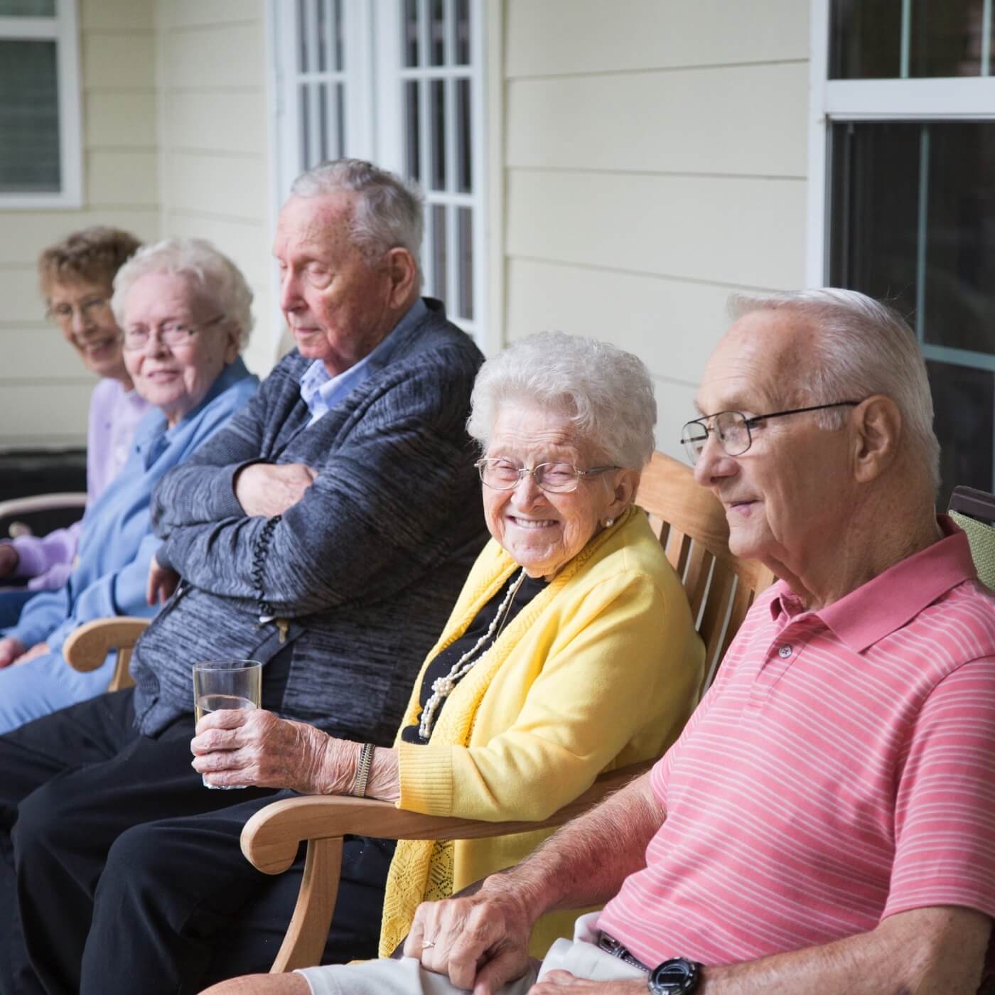 Group of residents sitting together on front porch