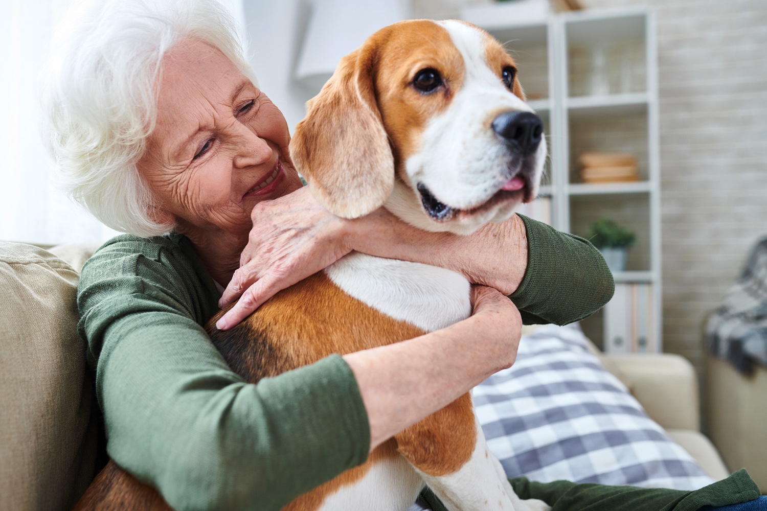 Senior woman hugging her dog