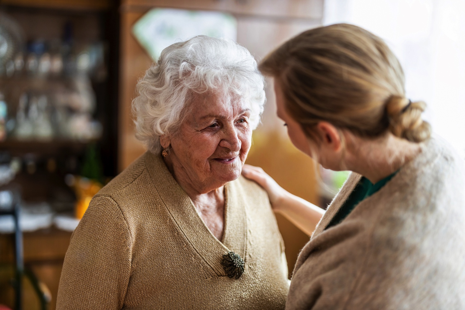 Staff member talking to a senior woman