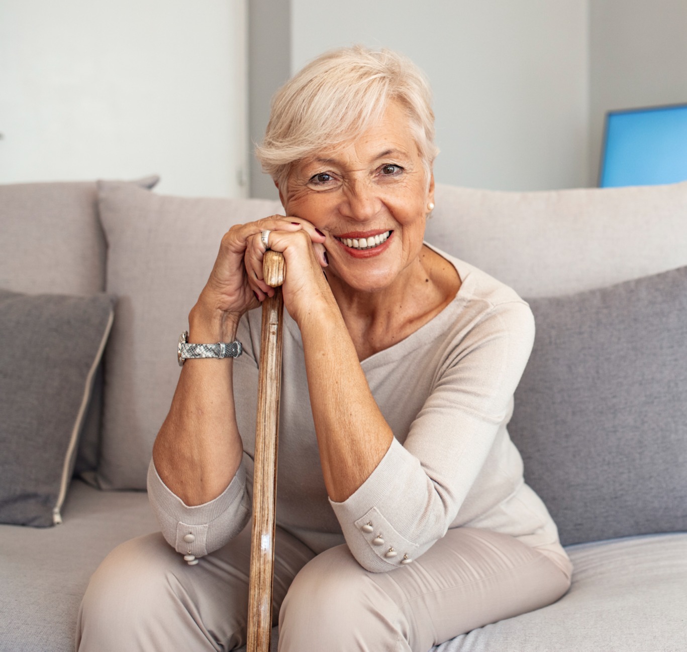 smiling senior woman sitting with walking stick