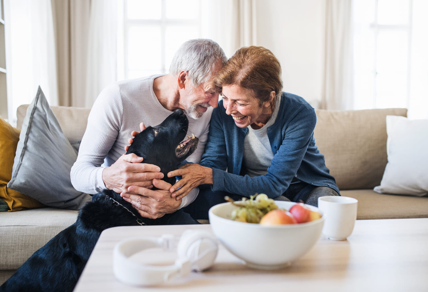 senior couple hugging pet dog