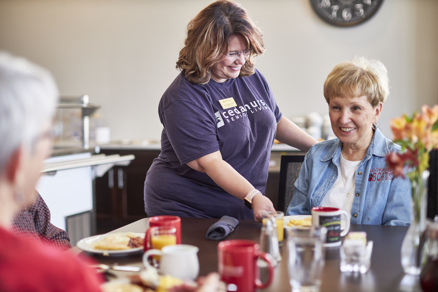 Caregiver serving food to resident