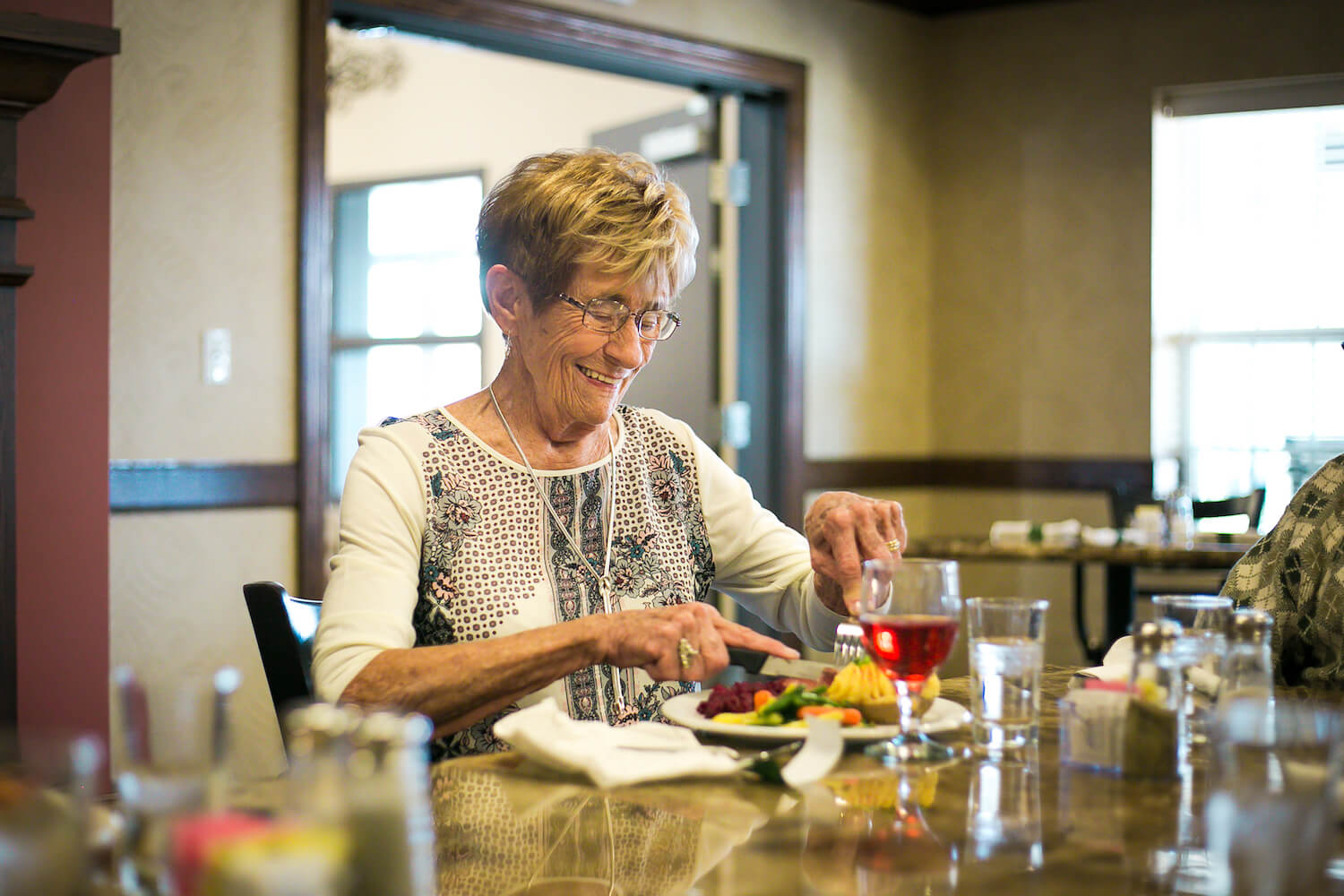 woman eating in dining room