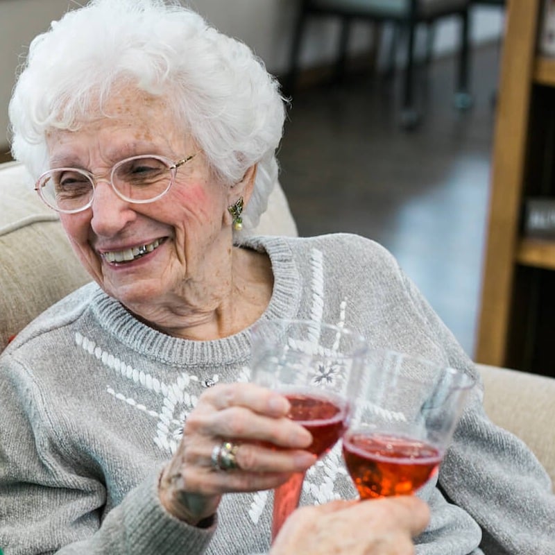 smiling senior woman drinking wine