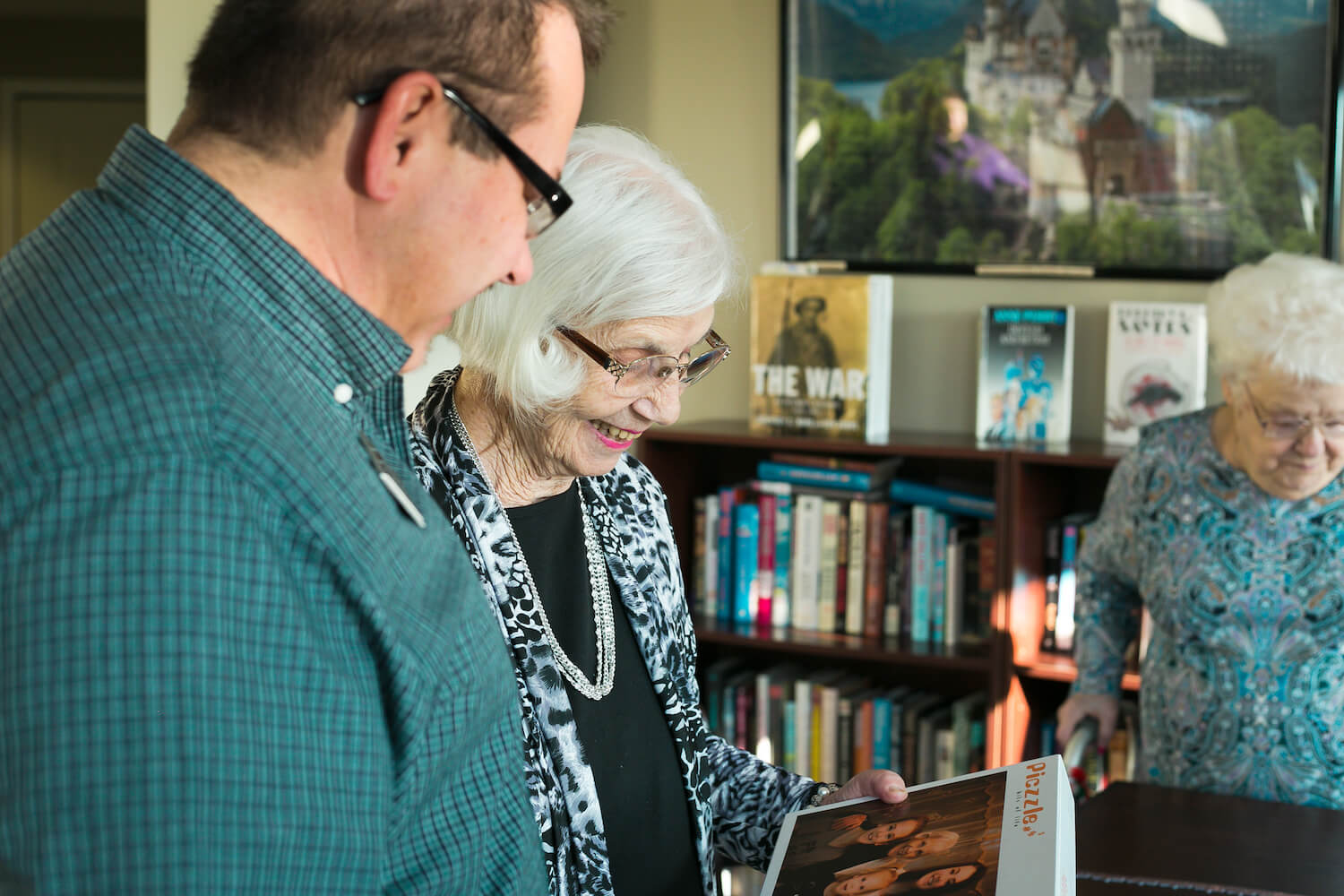 Staff member reading with a senior woman