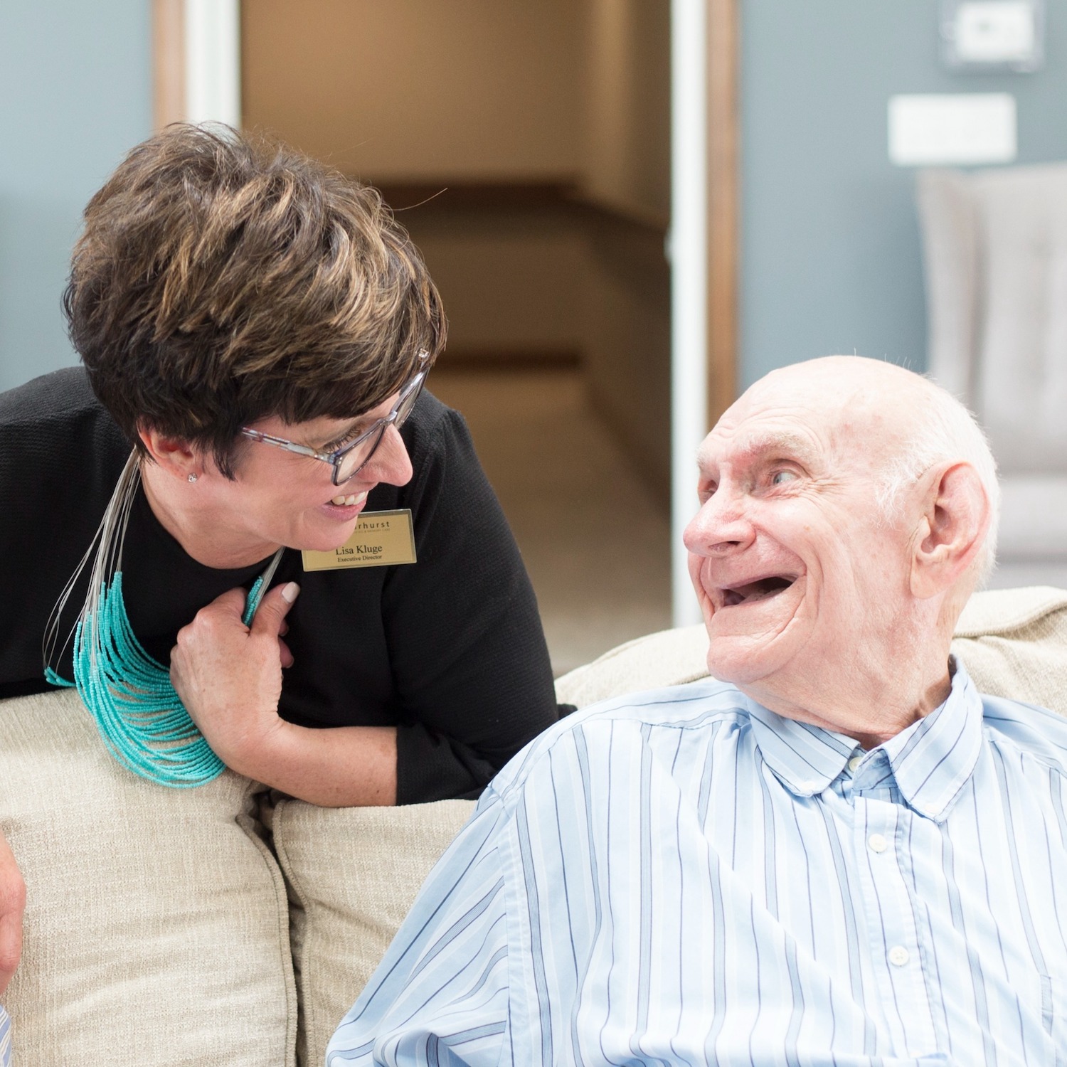 Staff member and senior man chatting