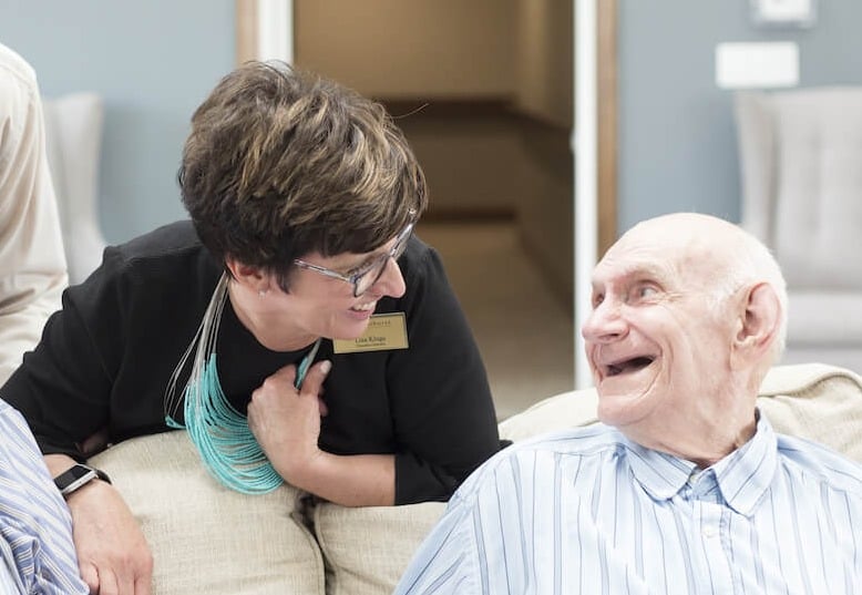 caregiver smiling with resident