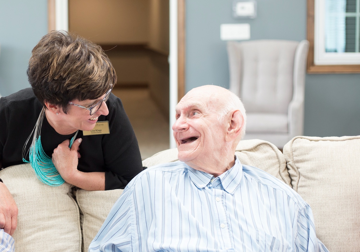 Senior man and staff member laughing