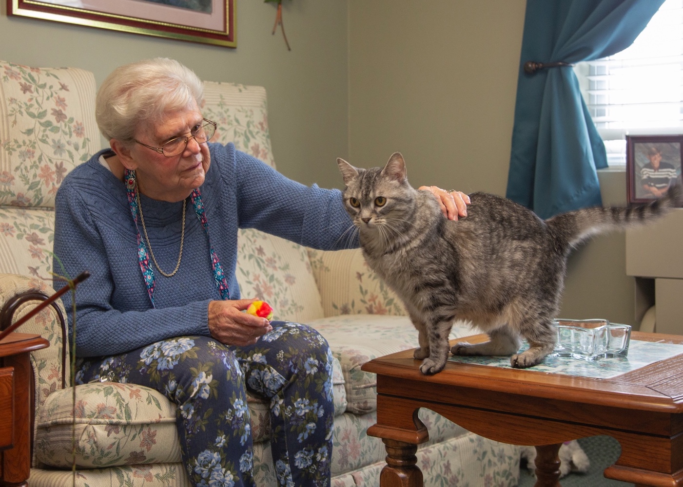 Senior woman petting her cat