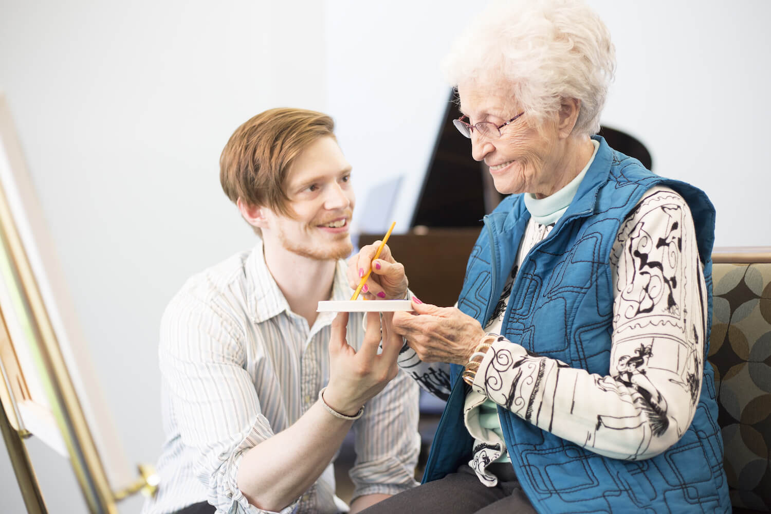 staff helping senior woman