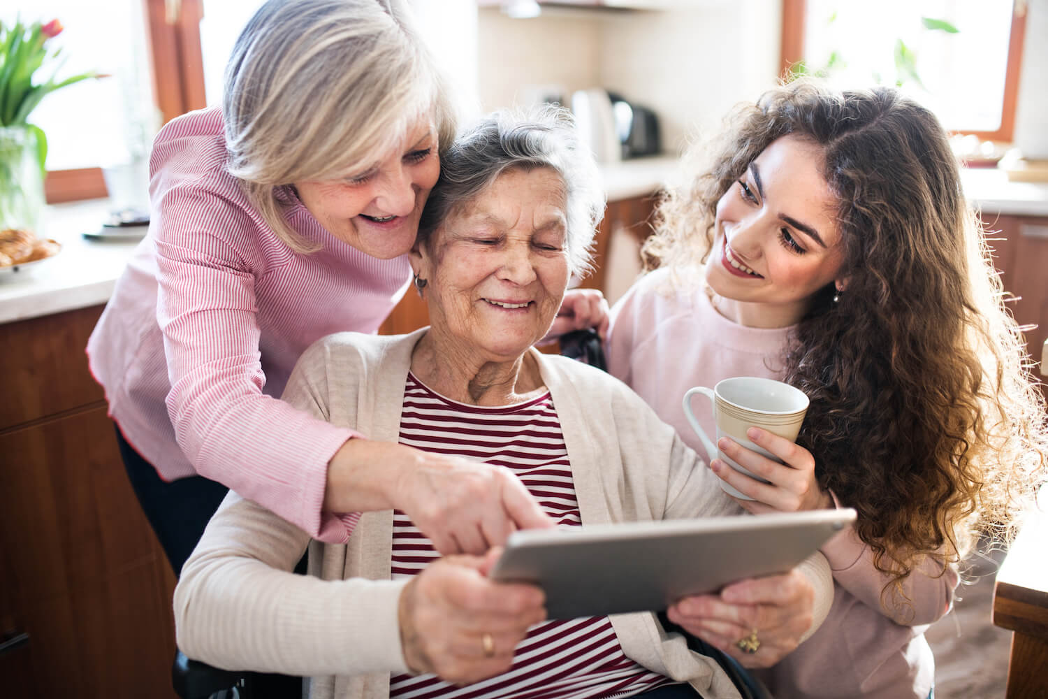 A multigenerational family looking at a digital tablet together