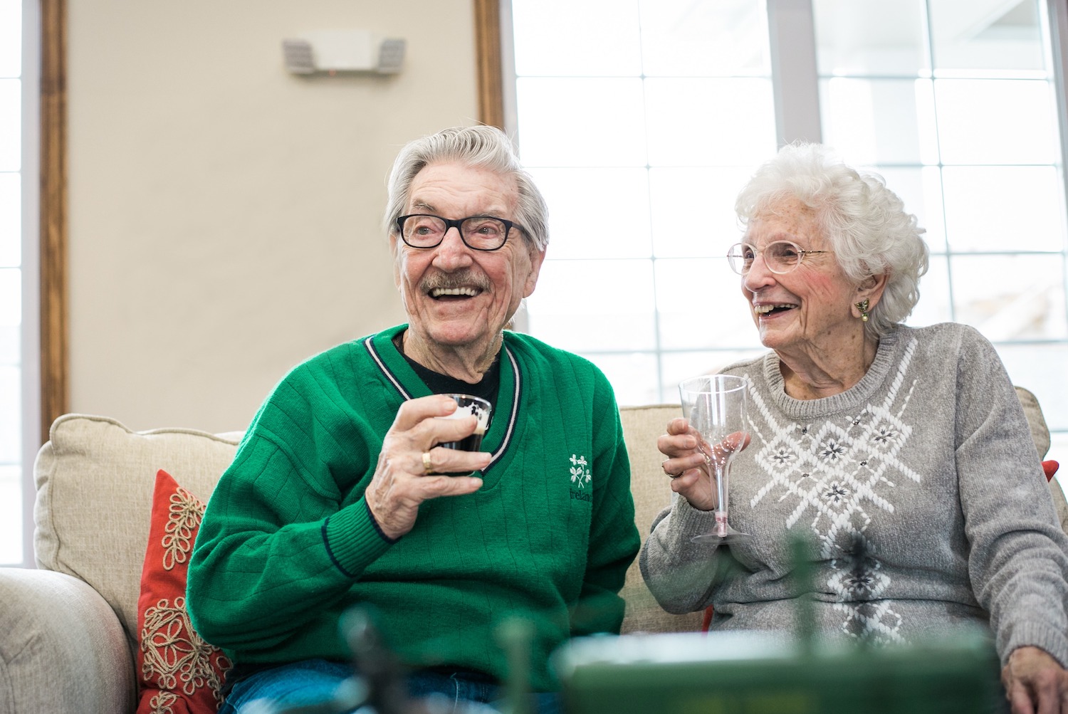 Resident couple laughing on couch