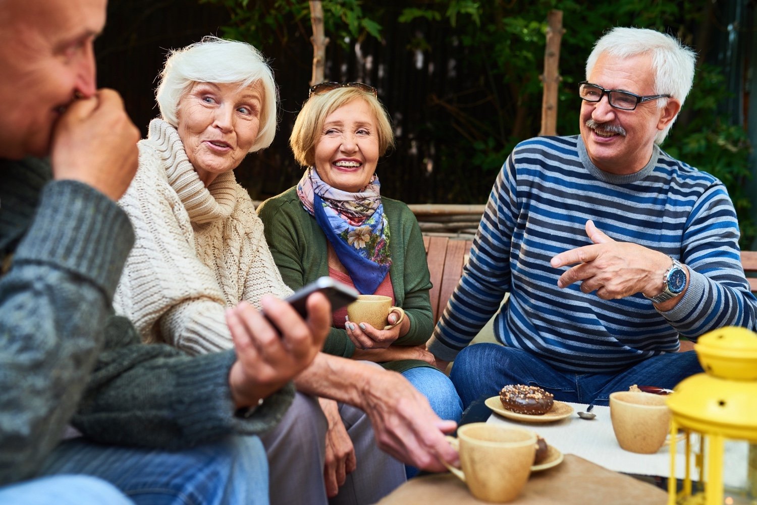 Senior friends socializing on a patio