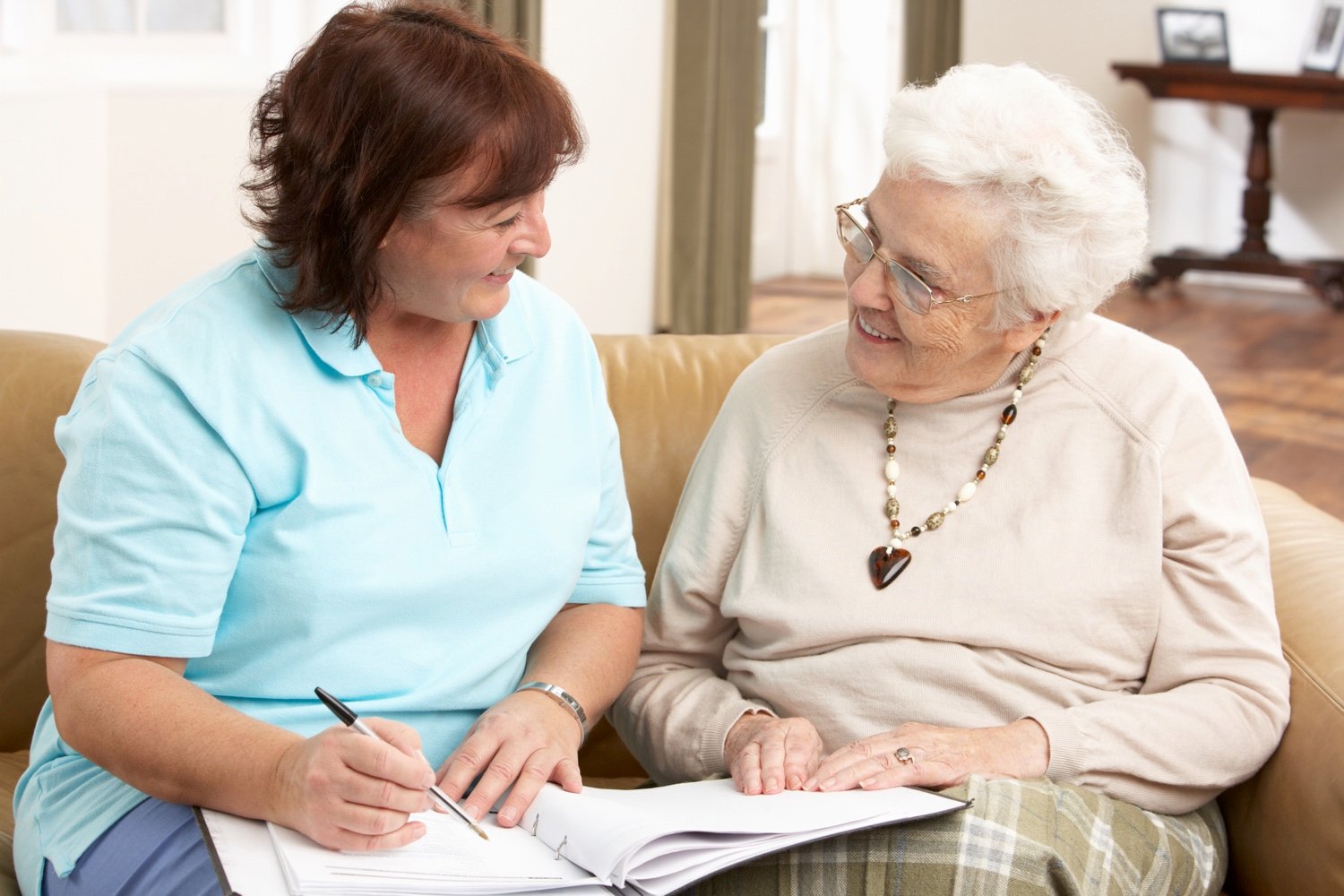 A senior woman in discussion with a healthcare worker