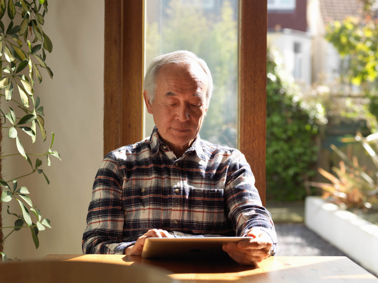 Senior man reading in living room