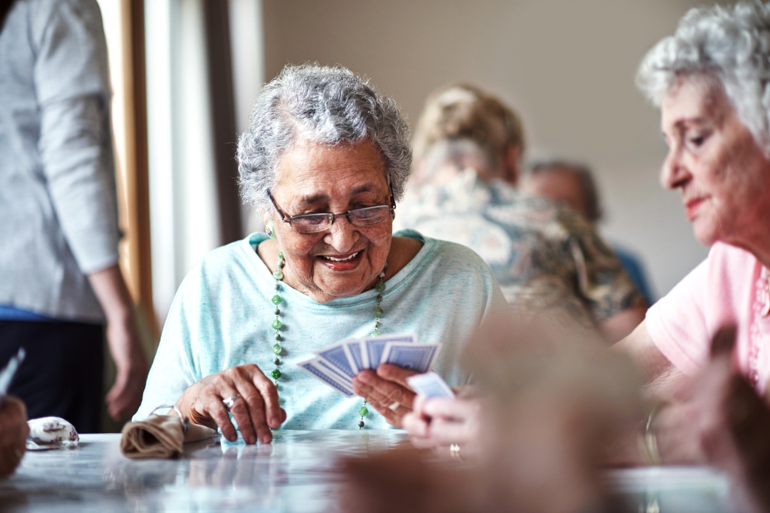 Senior woman playing cards