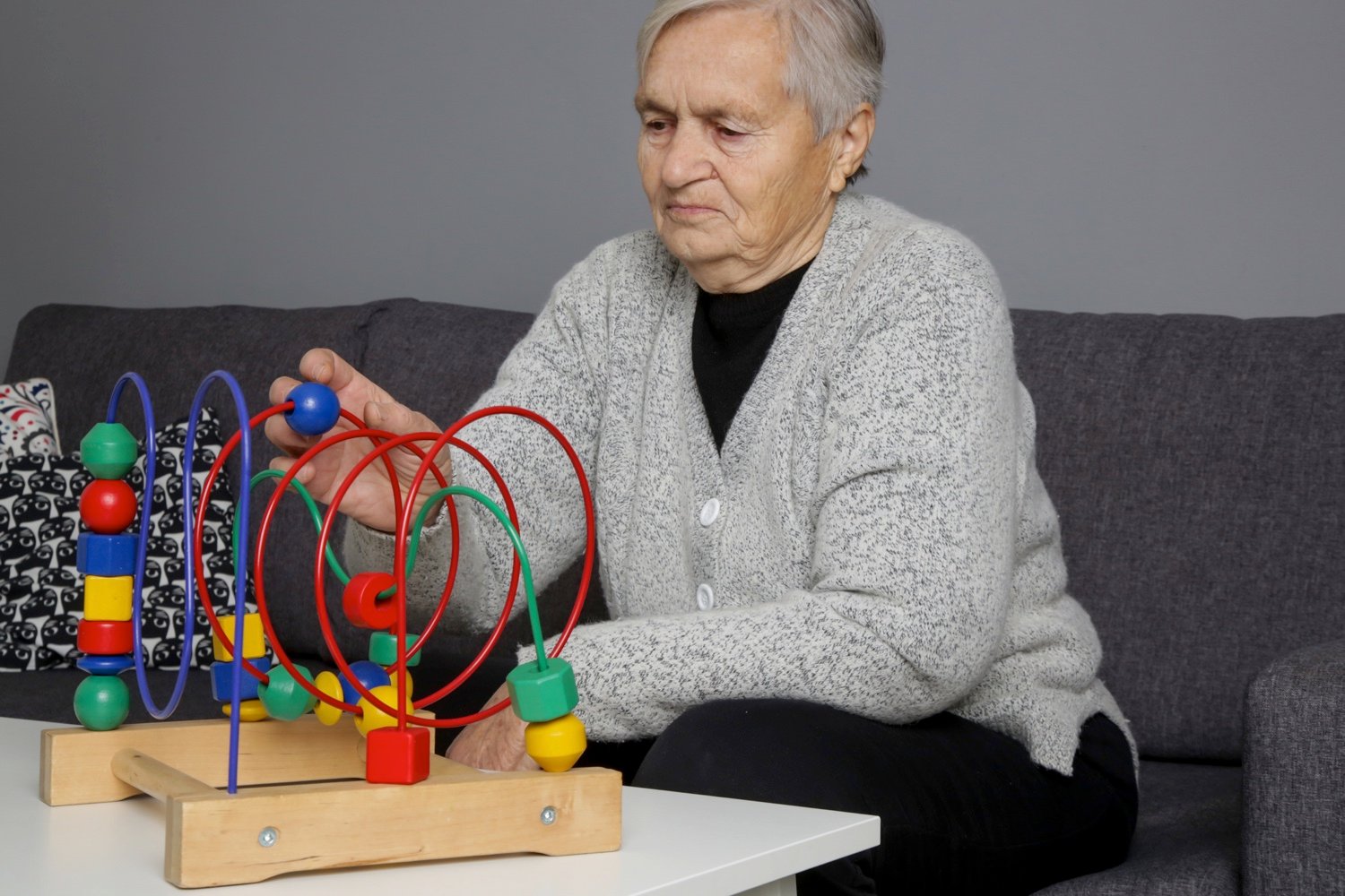 Senior woman preventing Alzheimer’s disease and dementia—or slowing its progress by supporting learning and memory through game-1308455115