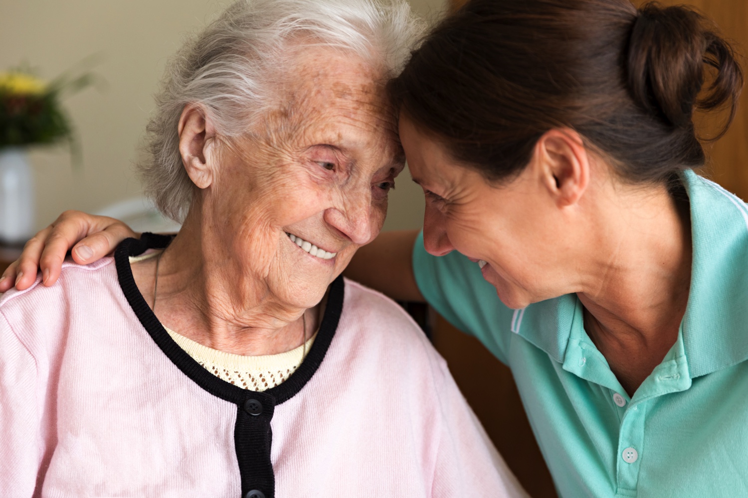 Senior woman embracing a staff member