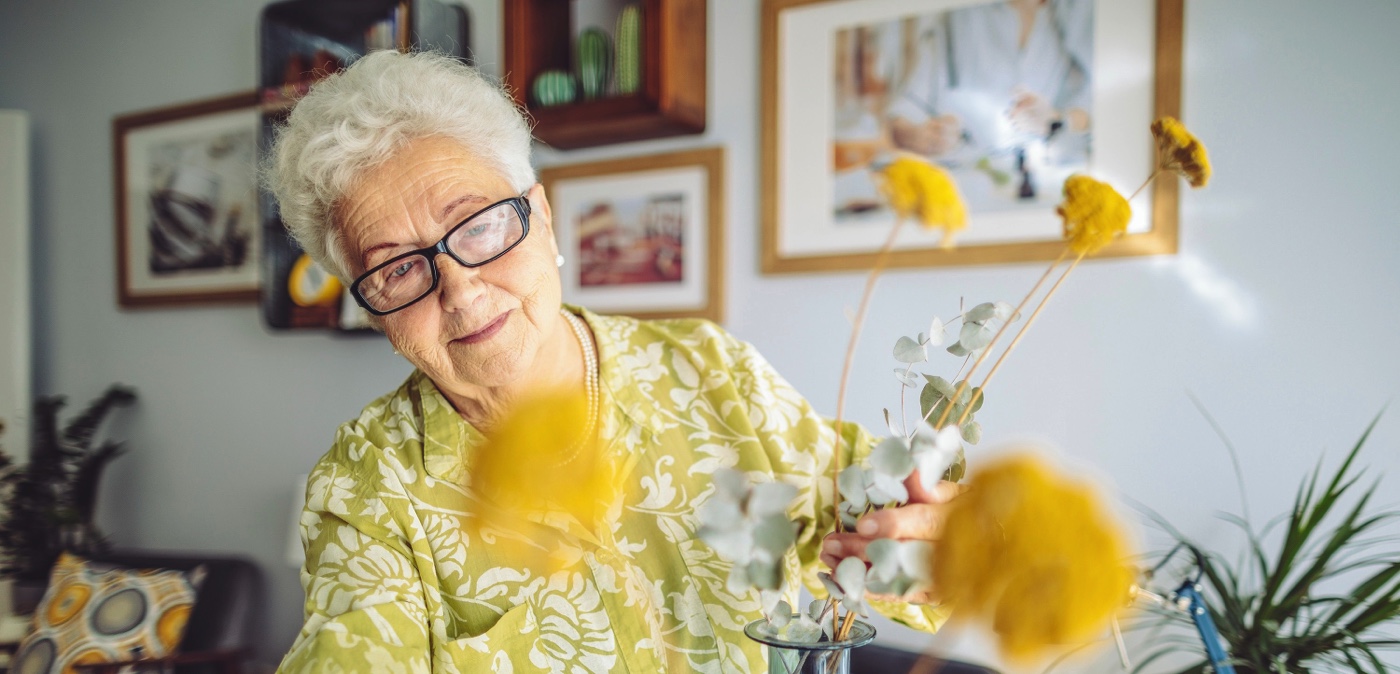 Senior woman arranging flowers