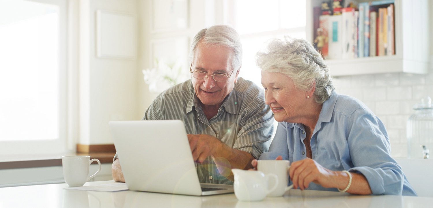 Seniors looking at a laptop computer together