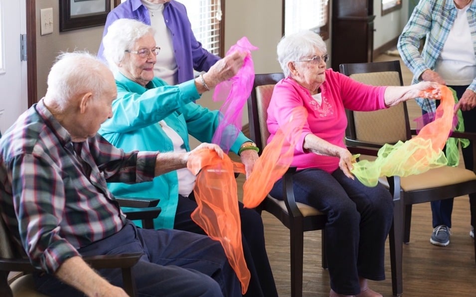 Group of seniors playing with fabrics