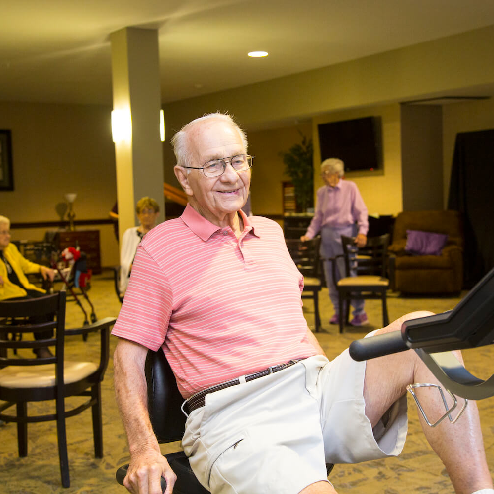 A resident exercising on an exercise bike