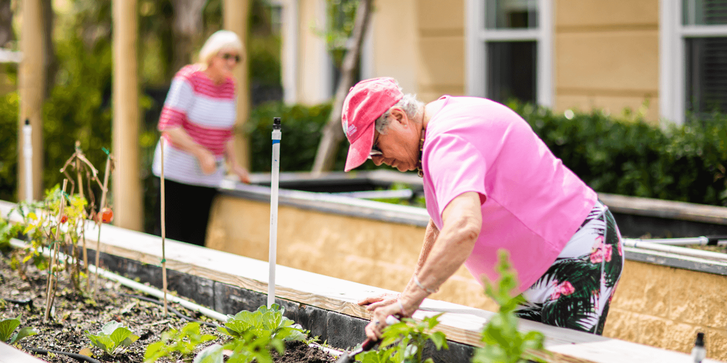 A senior woman considers memory care while gardening
