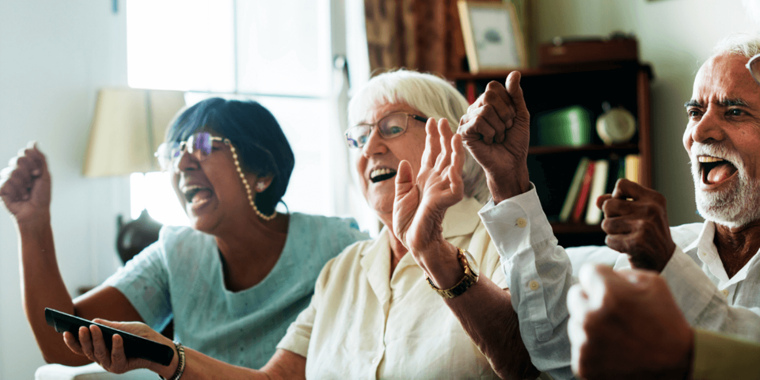 A group of assisted living residents sing along during a social gathering in their senior living facility. 