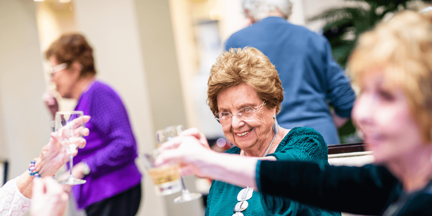 Senior residents toasting during a social gathering