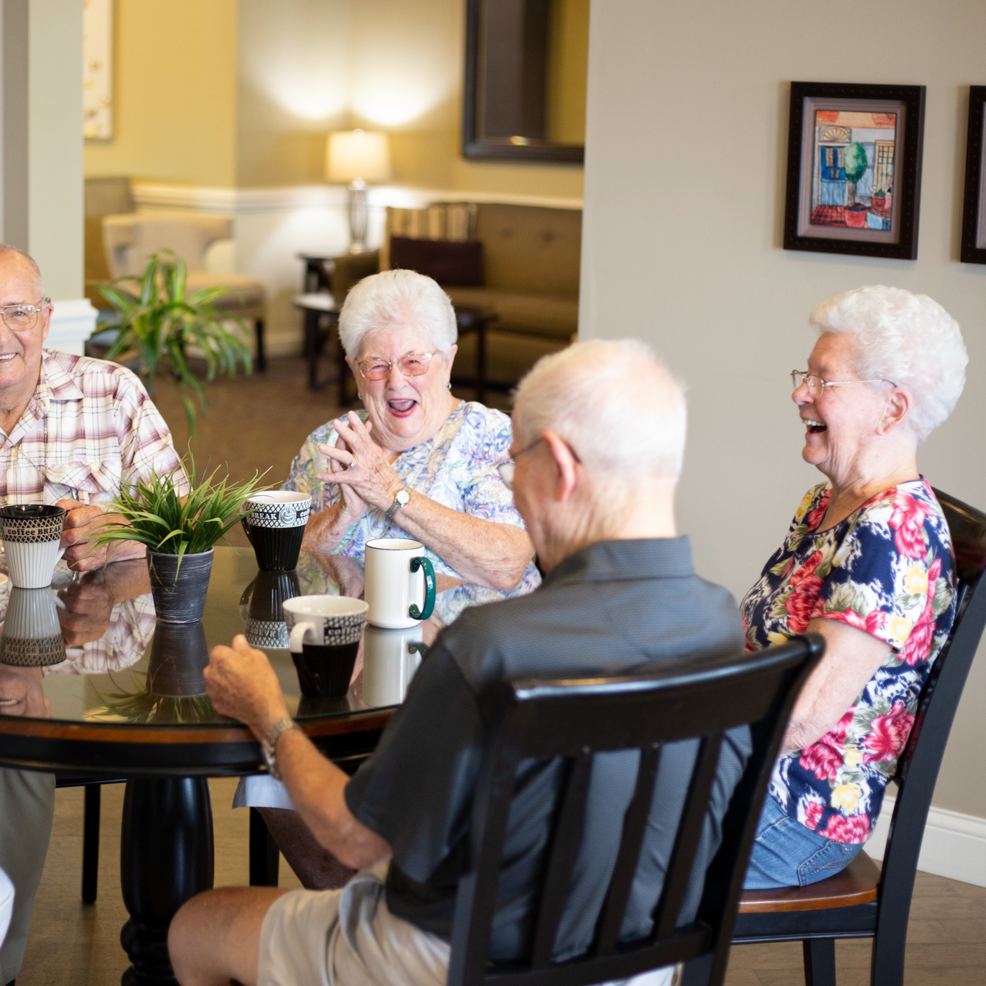 residents having coffee at a table and laughing