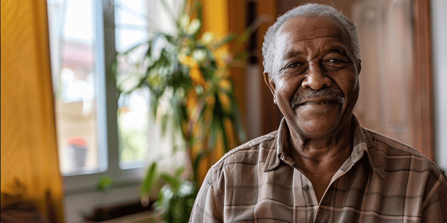 Man holding moving box as he prepare to move into senior living community.