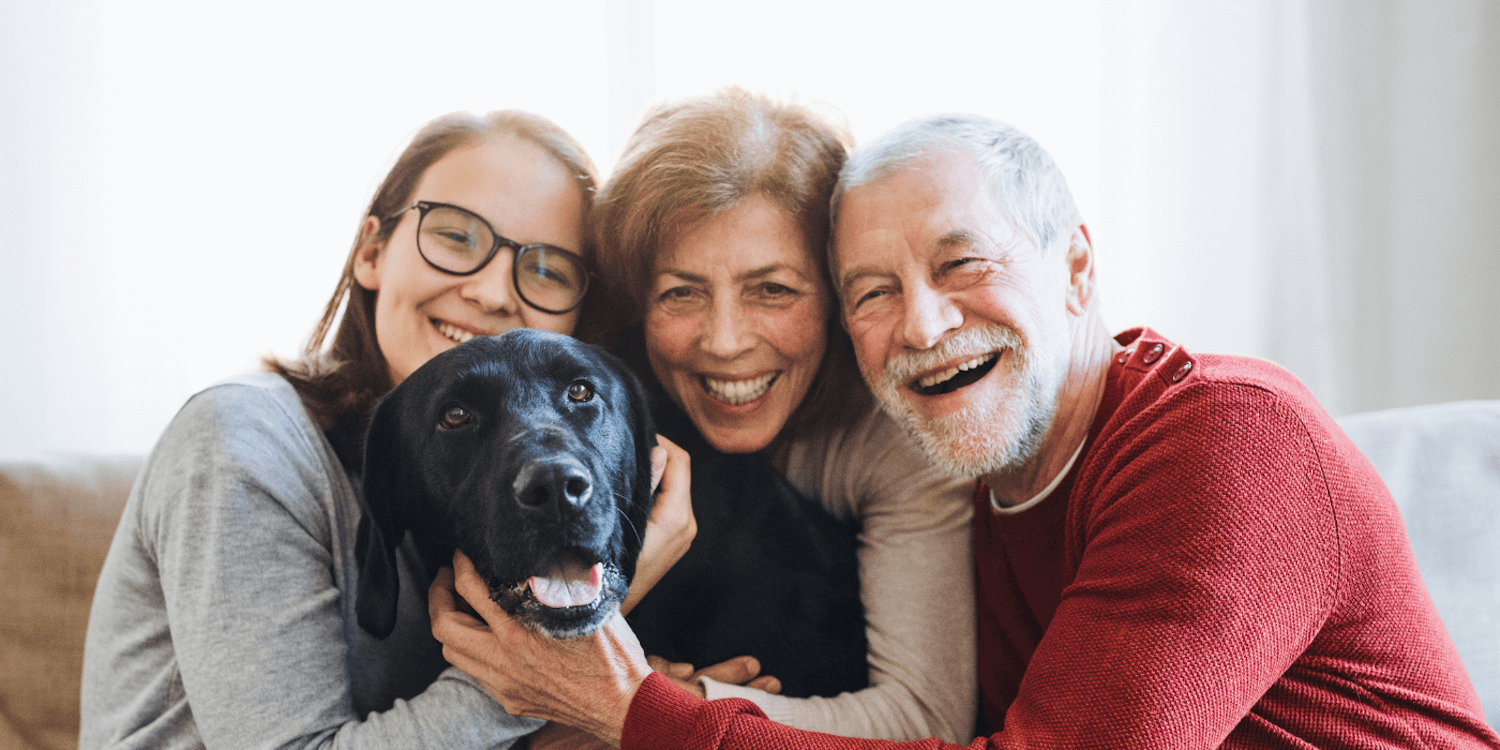 adult child with aging parents and pet dog find support and connection at senior living community