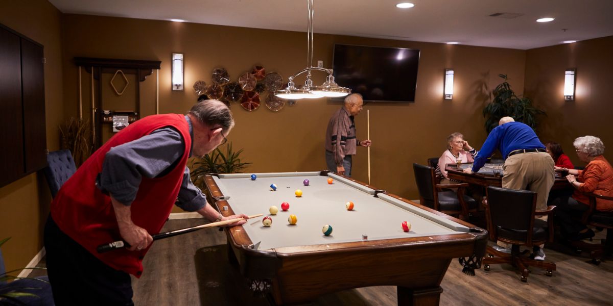 Independent living resident playing pool