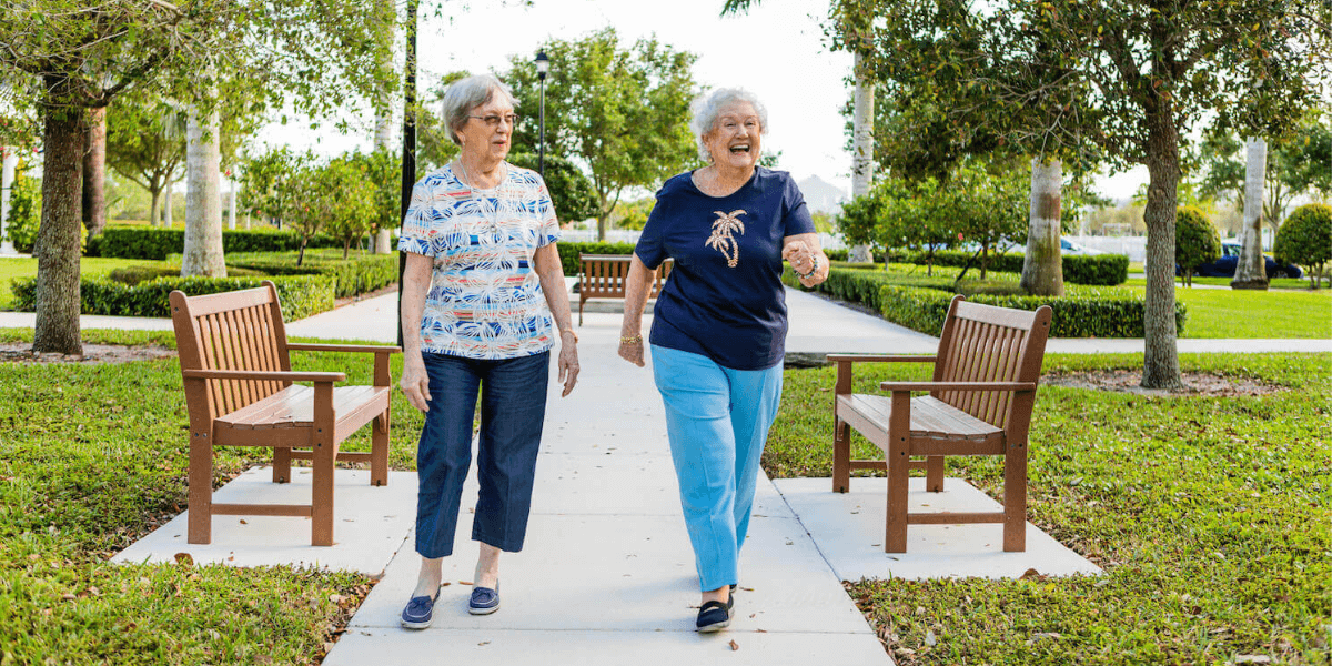 Two senior living residents walking around a Cedarhurst community. 