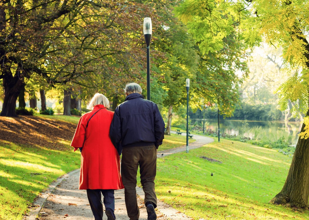 seniors walking on a path on a day in autumn