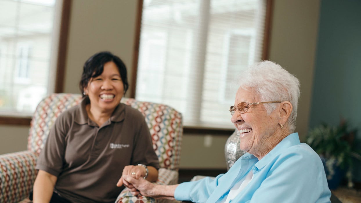 Caregiver holding hands with senior adult