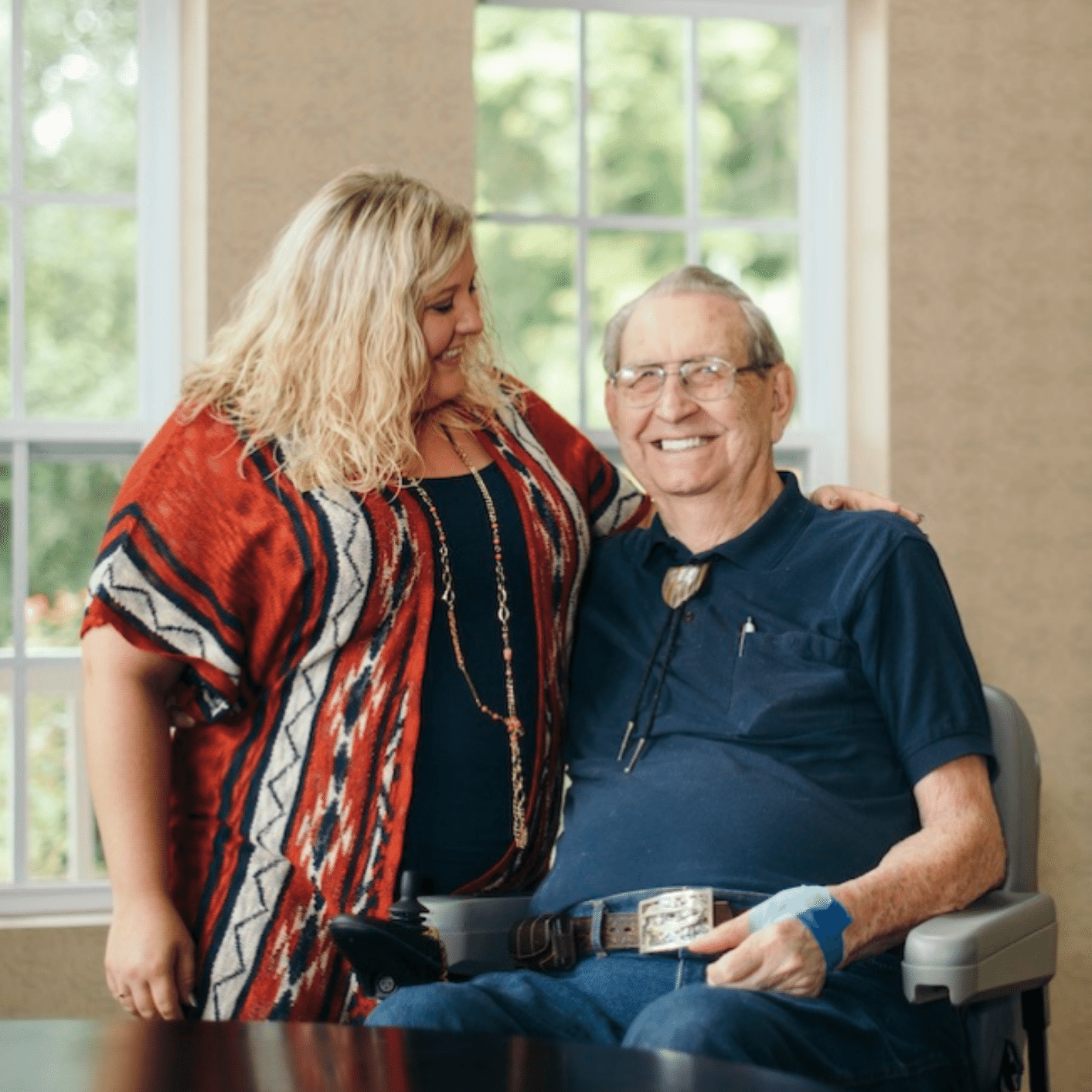 A caregiver and a resident smiling together