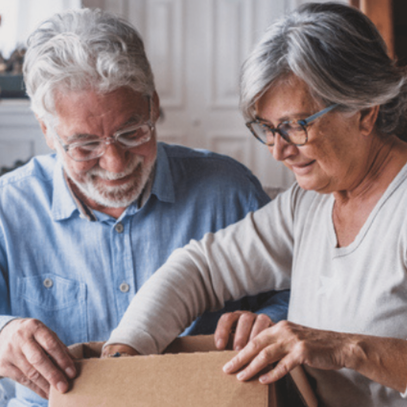 Couple packing a moving box